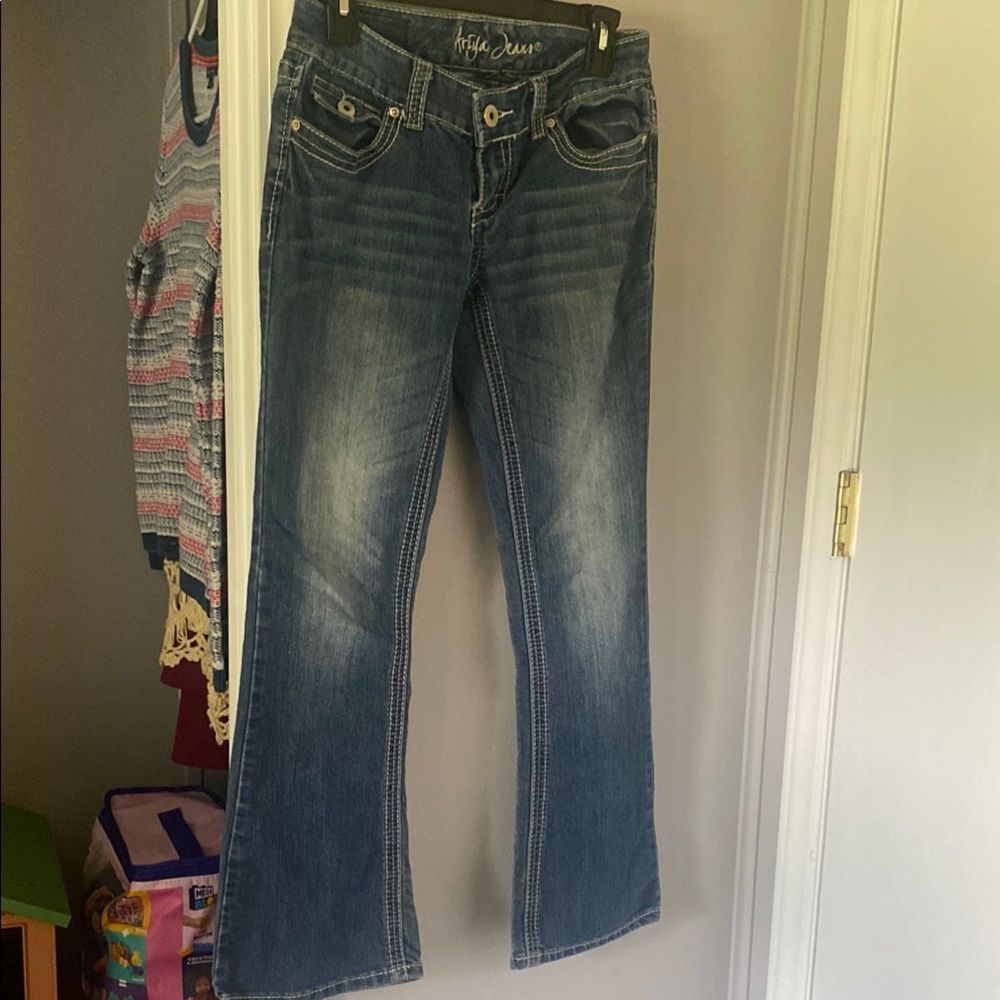 Ariya Jeans blue washed boot cut with white stitching.